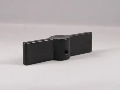 A black plastic object with a hole